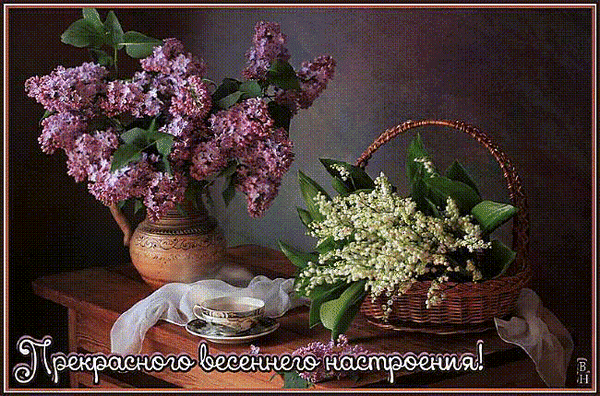 Весенний натюрморт с сиренью в вазе и ландышами в корзине. Уютная атмосфера, чашка чая и пожелание прекрасного весеннего настроения. Анимированная открытка Прекрасного весеннего настроения! Живописный натюрморт с весенними цветами: пышные гроздья фиолетовой сирени в керамической вазе и нежный букет ландышей в плетеной корзинке на деревянном столе. Рядом стоит изящная чашка чая, создавая атмосферу уюта и спокойствия. Теплые тона, мягкое освещение и эстетика весеннего утра