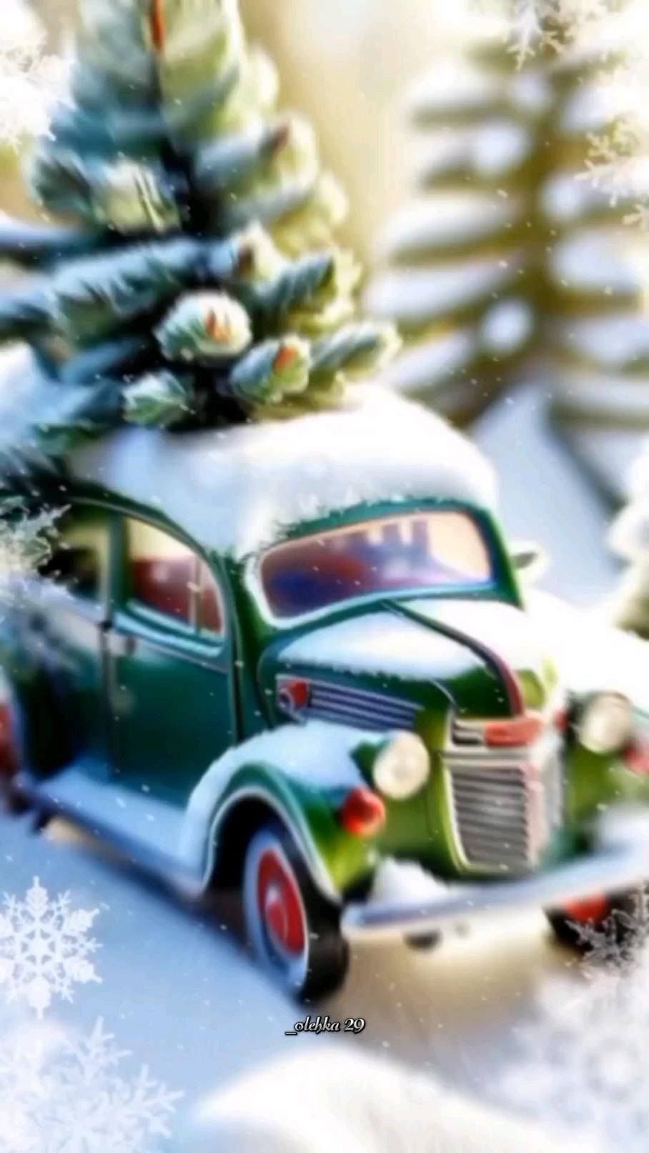 Открытка с Новым годом. an old green truck with a christmas tree on top is parked in front of snow covered trees