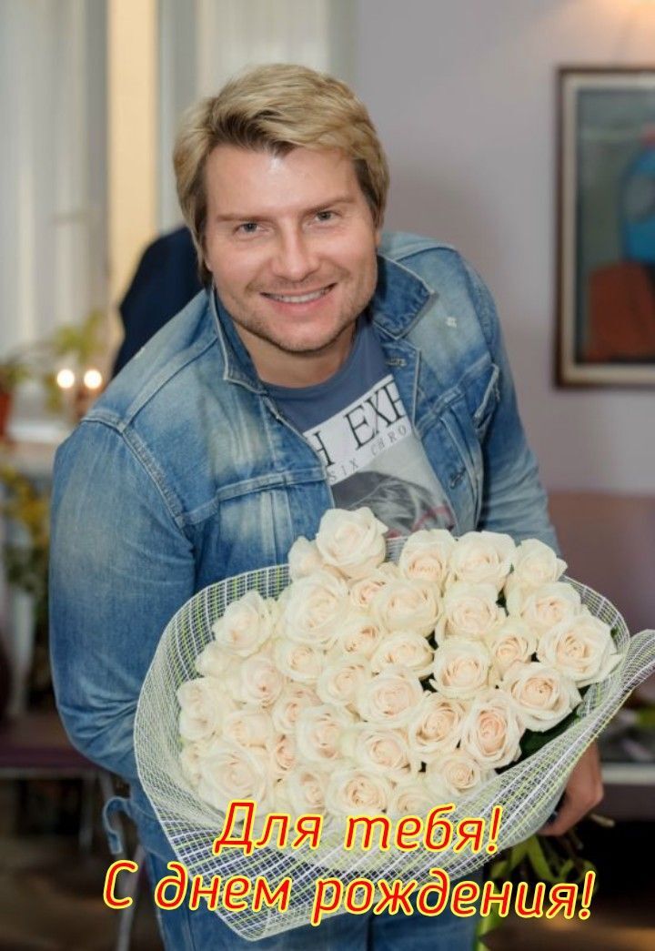 Открытка с днем рождения женщине. Басков holding a bouquet of white roses in his hands and smiling at the camera
