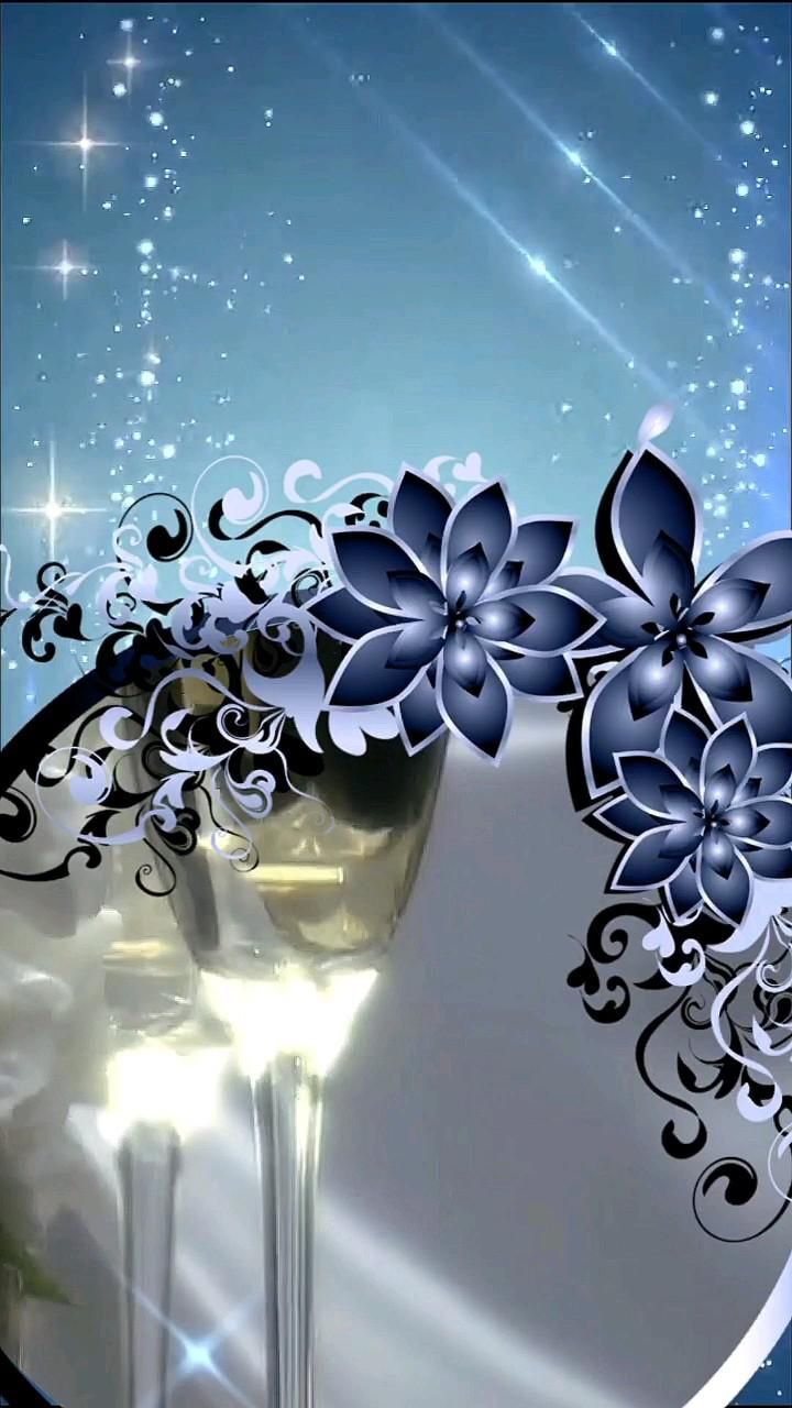 Открытка с днем свадьбы. фон two glasses of wine with blue flowers in the middle and sparkling lights behind them on a dark blue background